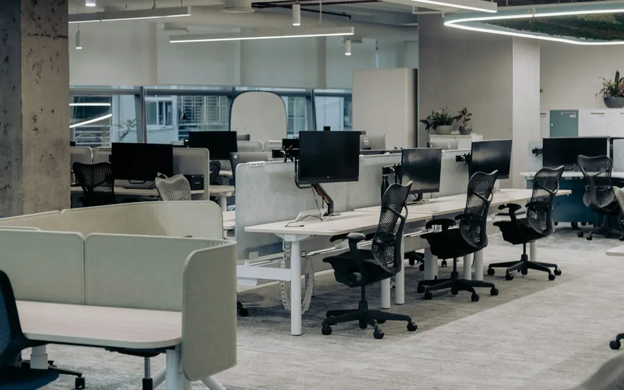 Bureau d’entreprise moderne et lumineux, postes avec écrans minces.